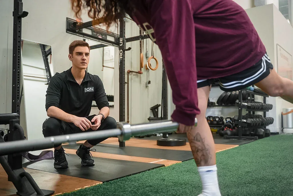 Dane guiding a client through an exercise at iON