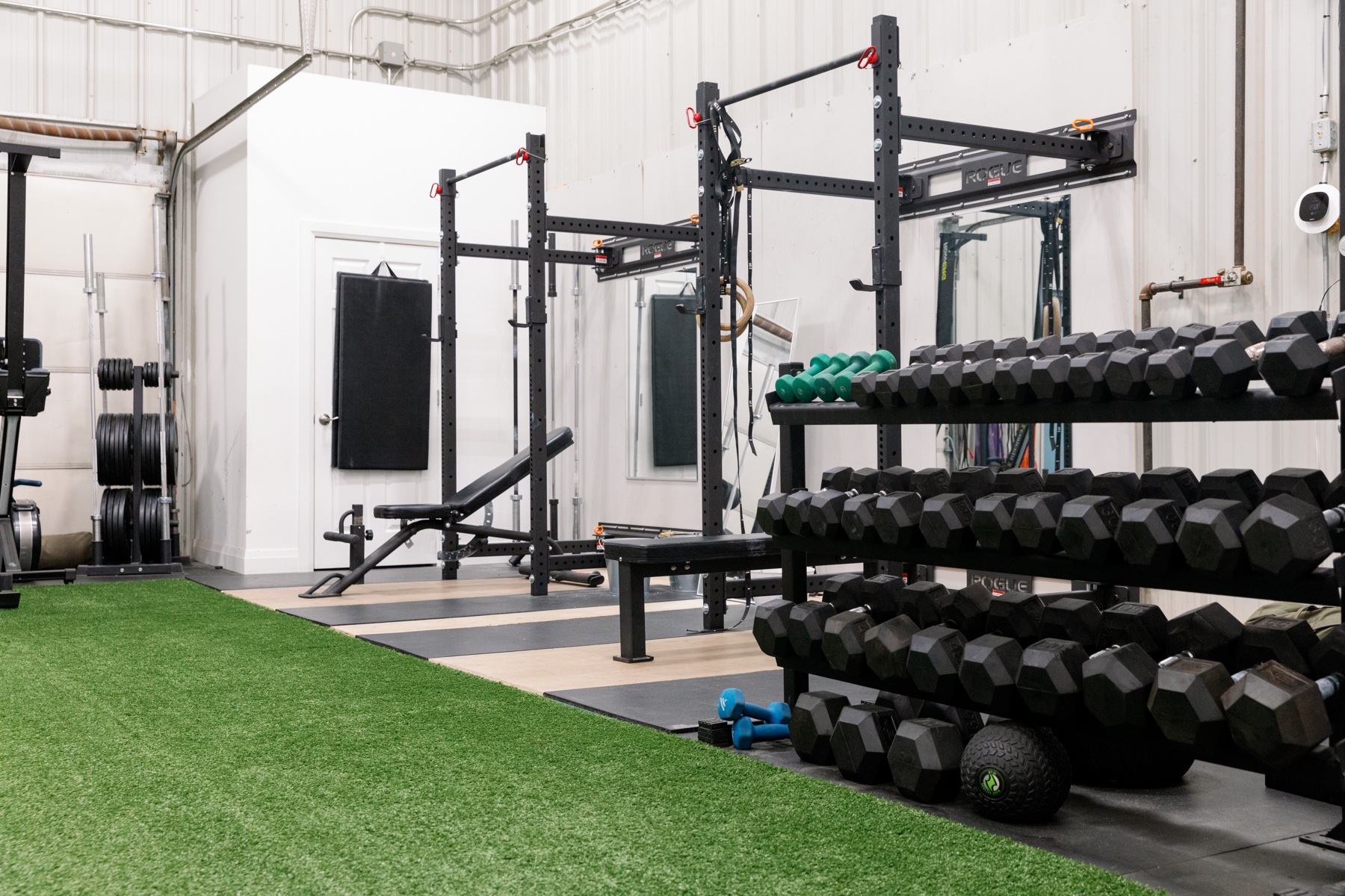 Dumbbells, squat racks and turf in the private training space at iON Guelph